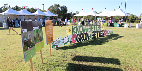 Photo of green grass, live plants and a yard sign stating, 