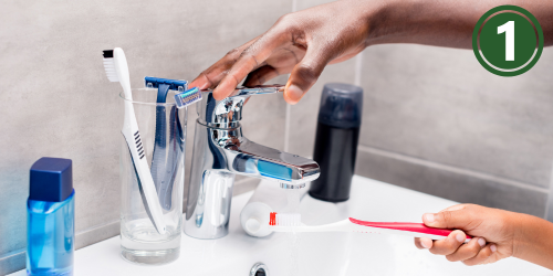 Person turning off faucet 