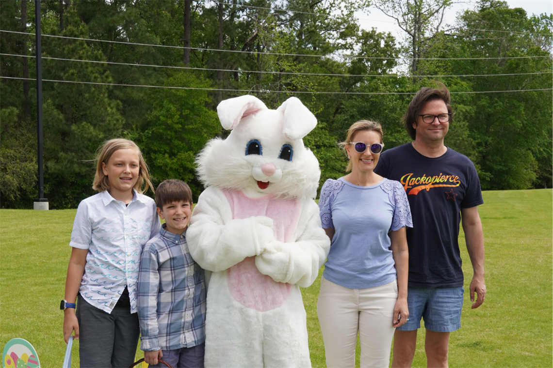 Photo of a family standing with the Easter Bunny