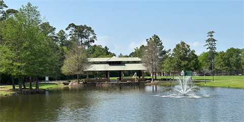 Photo of a pond with a fountain and pavilion