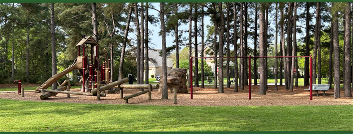 Photo of park playground with swings and slides