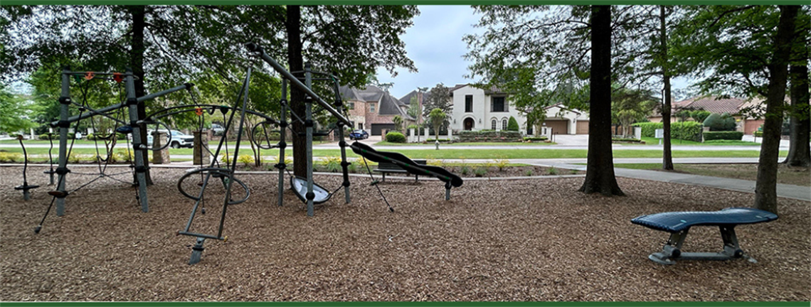 Photo of swings and a slide at a park