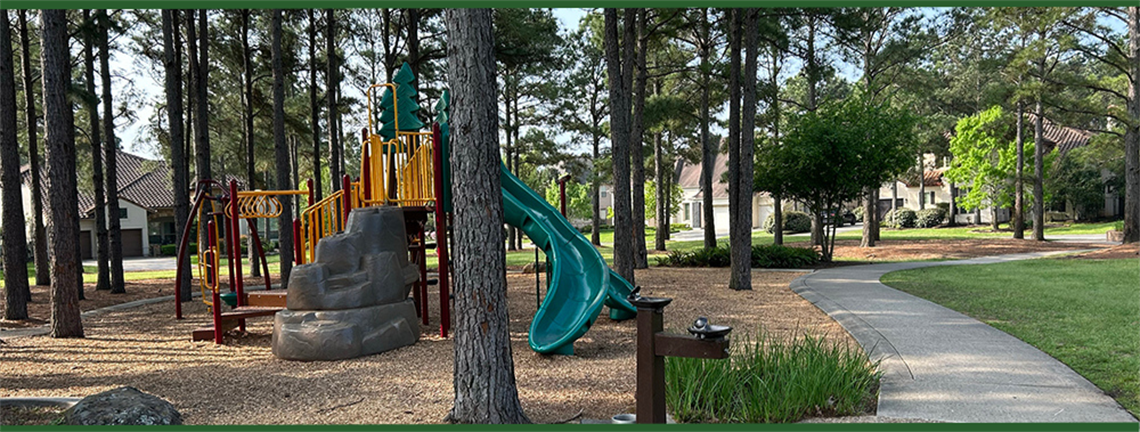 Photo of park play structure with slides and climbing rock