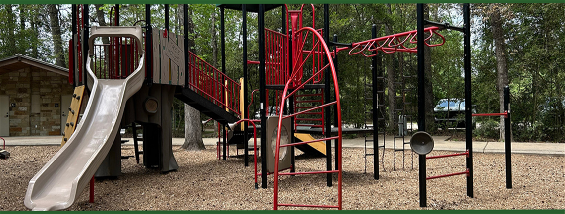 Photo of park playground with slides and climbing areas