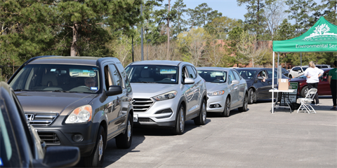 Cars in line to donate items to waiting attendants.