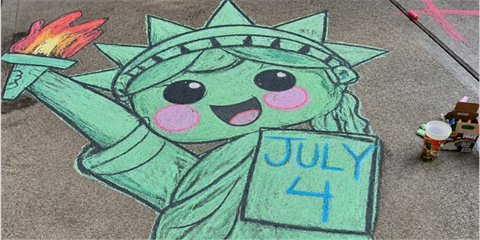 A smiling Statue of Liberty drawn in chalk