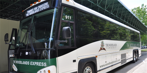 A white and green city commuter bus