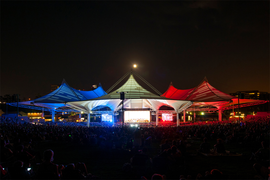 Photo of a red, white and blue lit pavilion