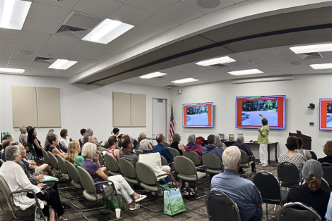 Group of people sitting and watching guest speaker