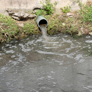 Water dumping from a storm drain into a waterway