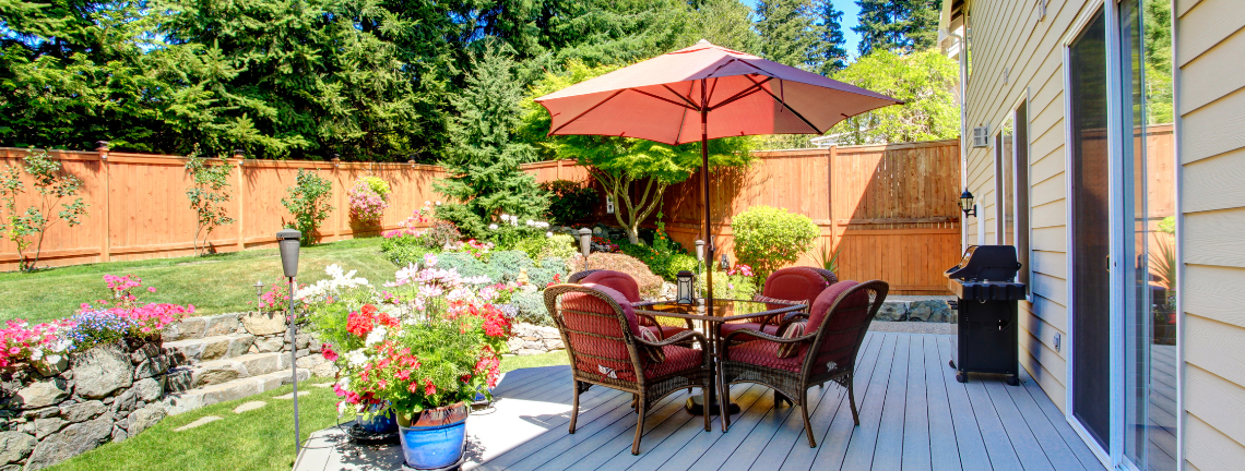 A patio with outdoor seating surrounded by flowers