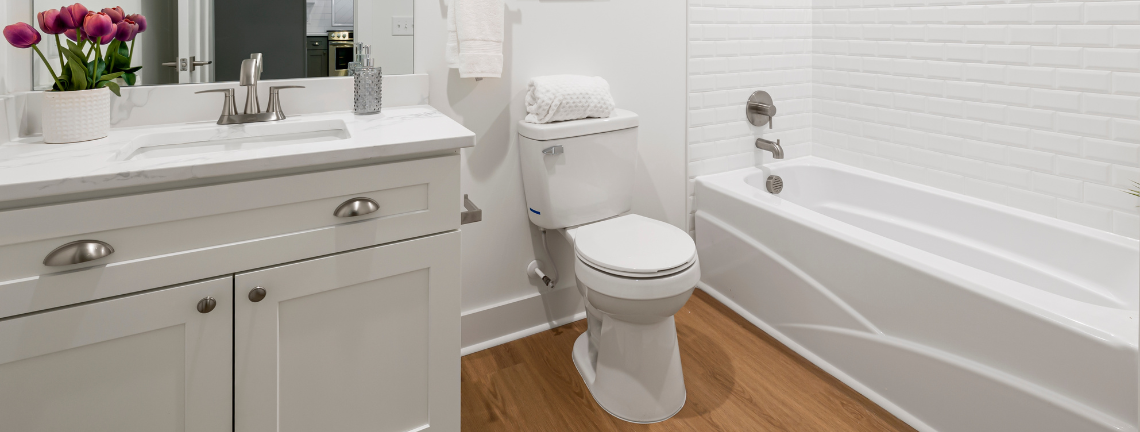 A view of a bathroom with a sink, toilet and bathtub
