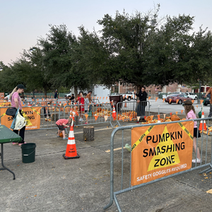 People smashing pumpkins at an event
