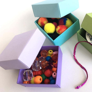 Multiple paper boxes filled with crafting supplies