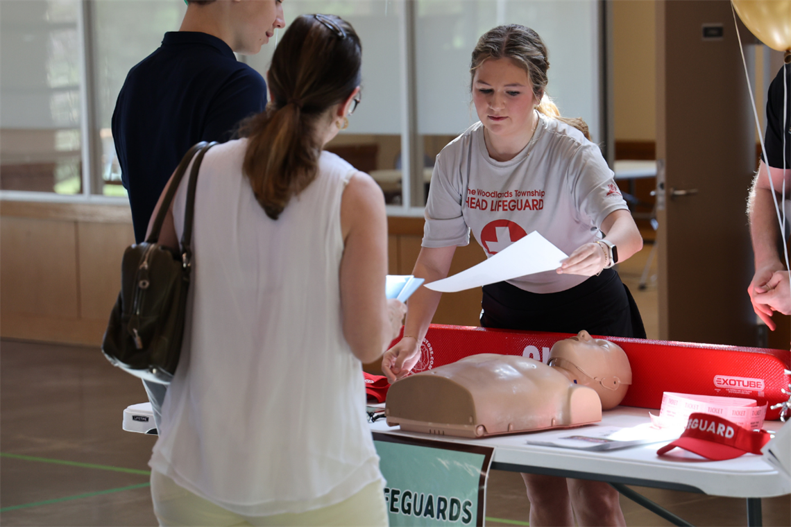 Image of a young adult handing out an informational flyer about hiring positions