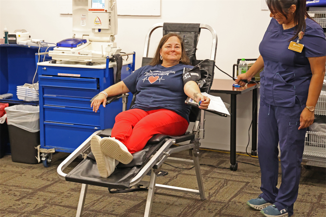 Photo of a smiling women giving blood