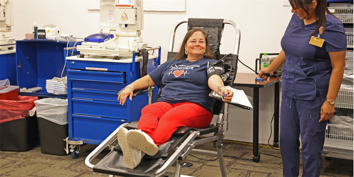 Photo of a smiling woman donating blood