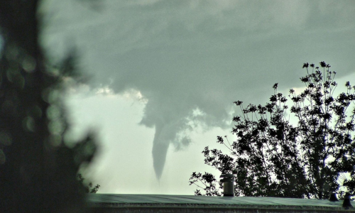 Photo of a tornado forming in the clouds