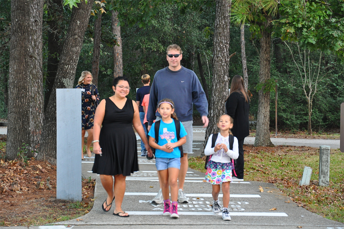 A family walking with children on a pathway